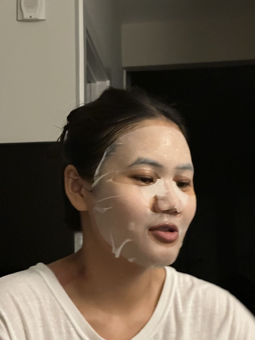 Yas wearing a white sheet face mask