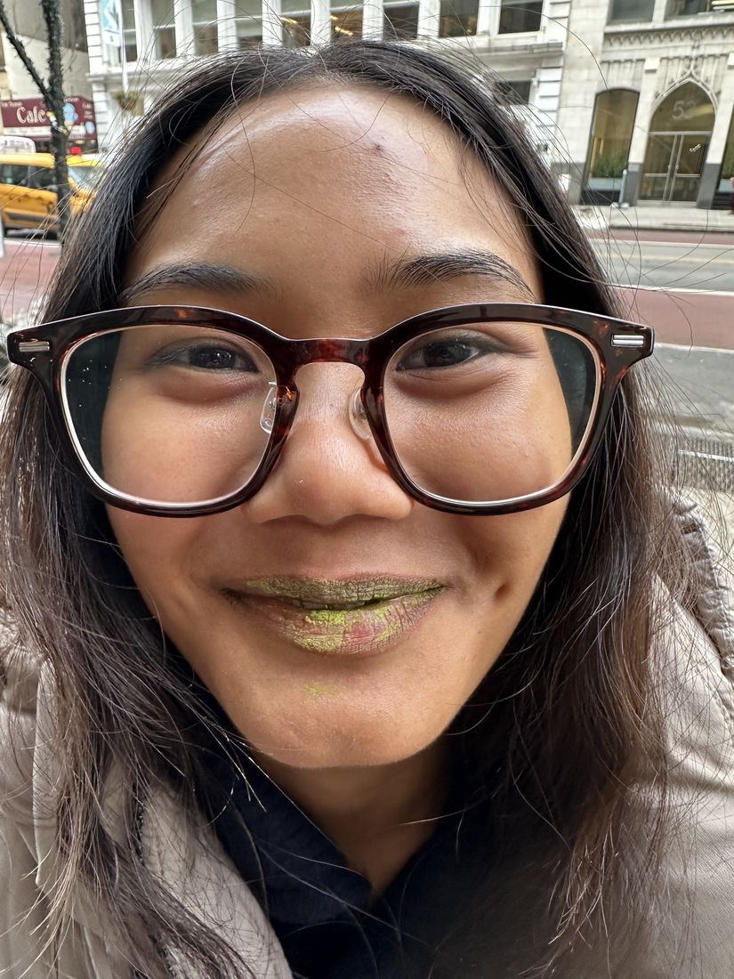 Close-up of Yas outdoors wearing green lipstick